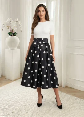 Fusta midi neagra cu buline albe si funda in talie